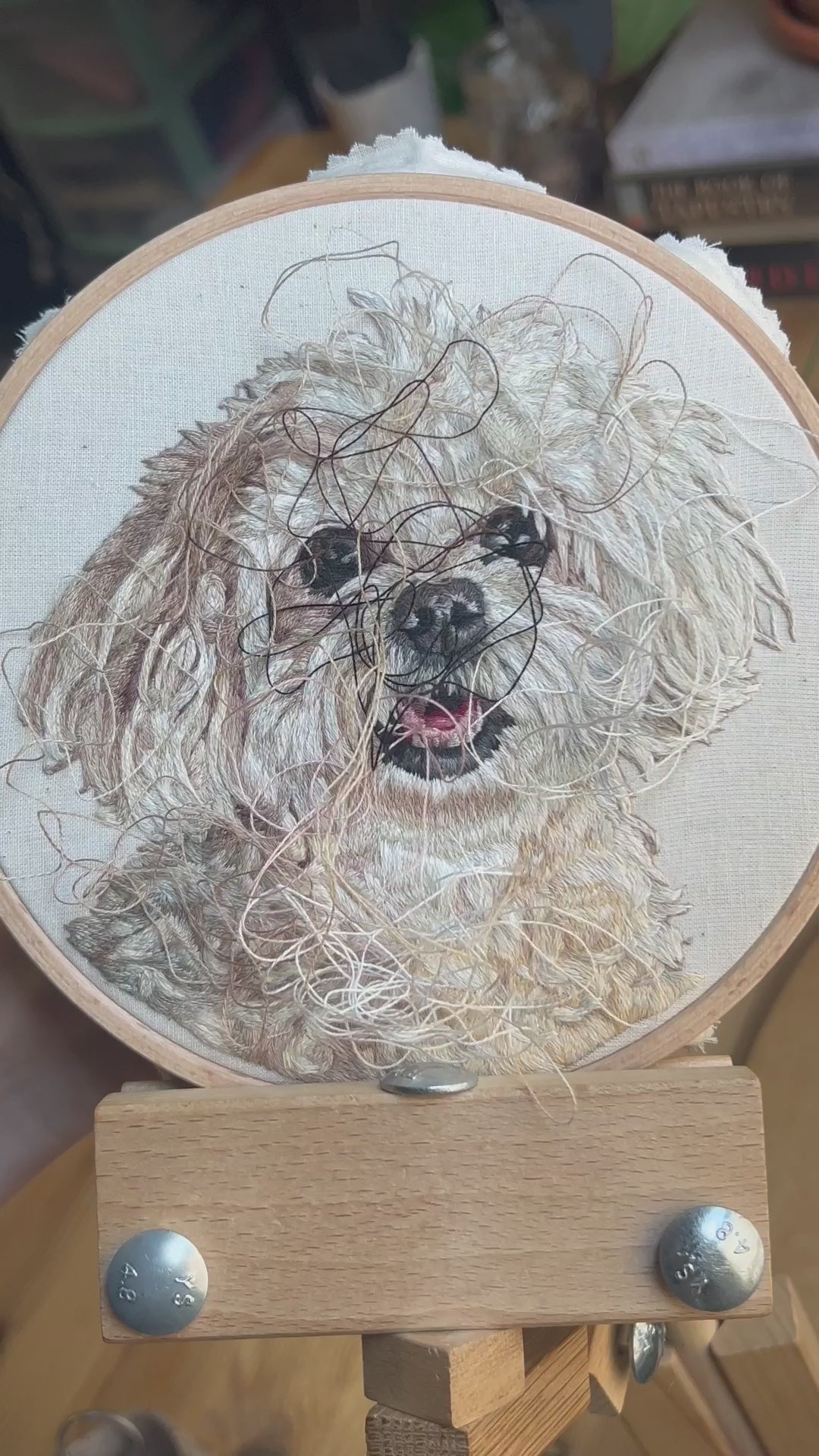 Load video: Nessie, Small white dog hand embroidery threads pulling